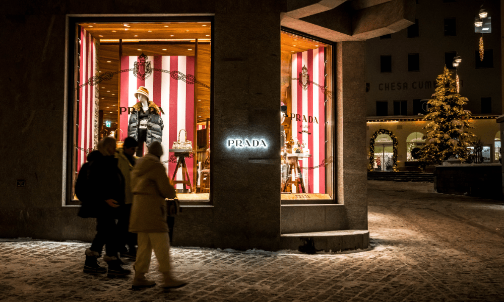Tourists walk past a shop of Italian luxury fashion house Prada in the Swiss Alps resort of St Moritz on December 20, 2024. Fabrice COFFRINI / AFP
