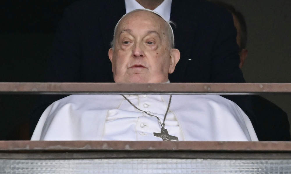 Pope Francis appears at a window of the Gemelli hospital before being discharged following a five weeks hospitalization for pneumonia, in Rome on March 23, 2025. Pope Francis is to leave hospital todayand return to his residence in the Vatican, where he is to spend "at least two months" recovering, one of his doctors announced during a press conference on March 22, 2025.