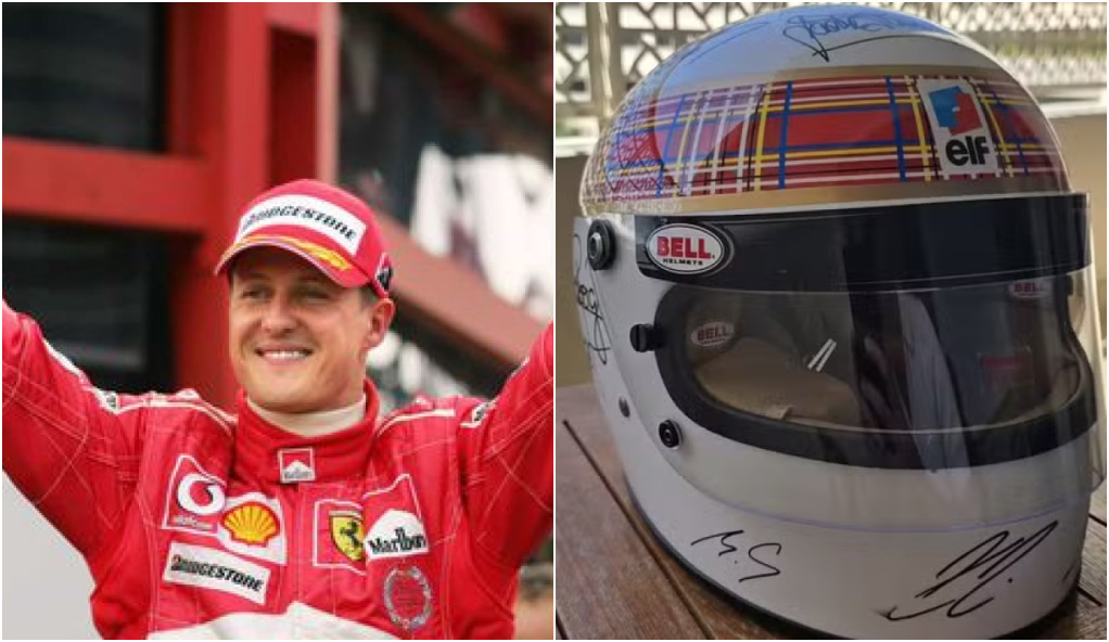 Com ajuda da esposa, Schumacher assina capacete em rara aparição em tributo da Fórmula 1
