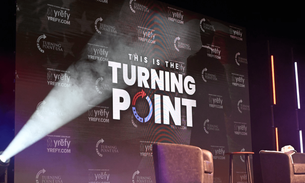 Logotipo da Turning Point USA é visto no palco durante uma parada da 'American Comeback Tour', no Burruss Hall da Universidade Virgina Tech